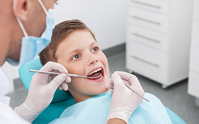 A young boy having his teeth worked on