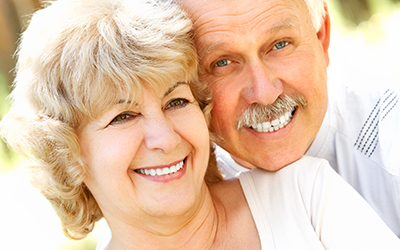 An elderly couple smiling together
